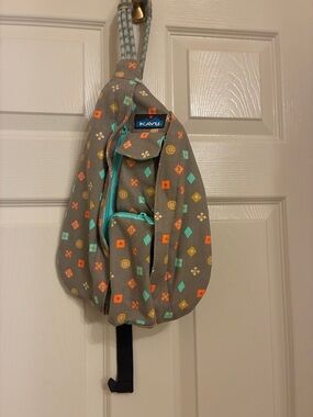 Kavu taupe sling bag with turquoise & orange geometric print